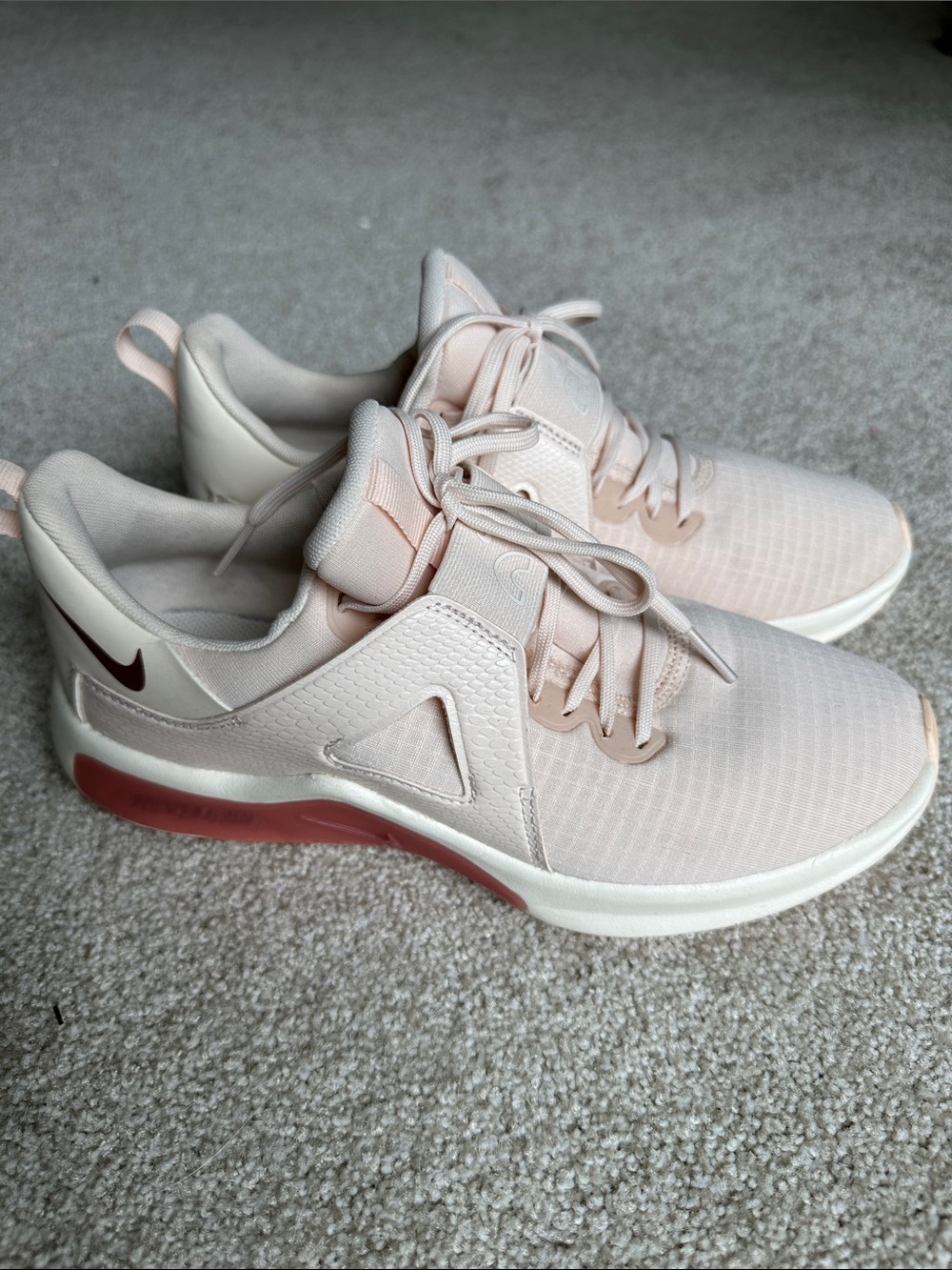 Nike Women's Light Pink Athletic Sneakers with Maroon Accent